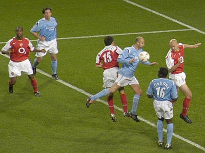 Sibierski and young Spanish star Fabregas clash at a corner.